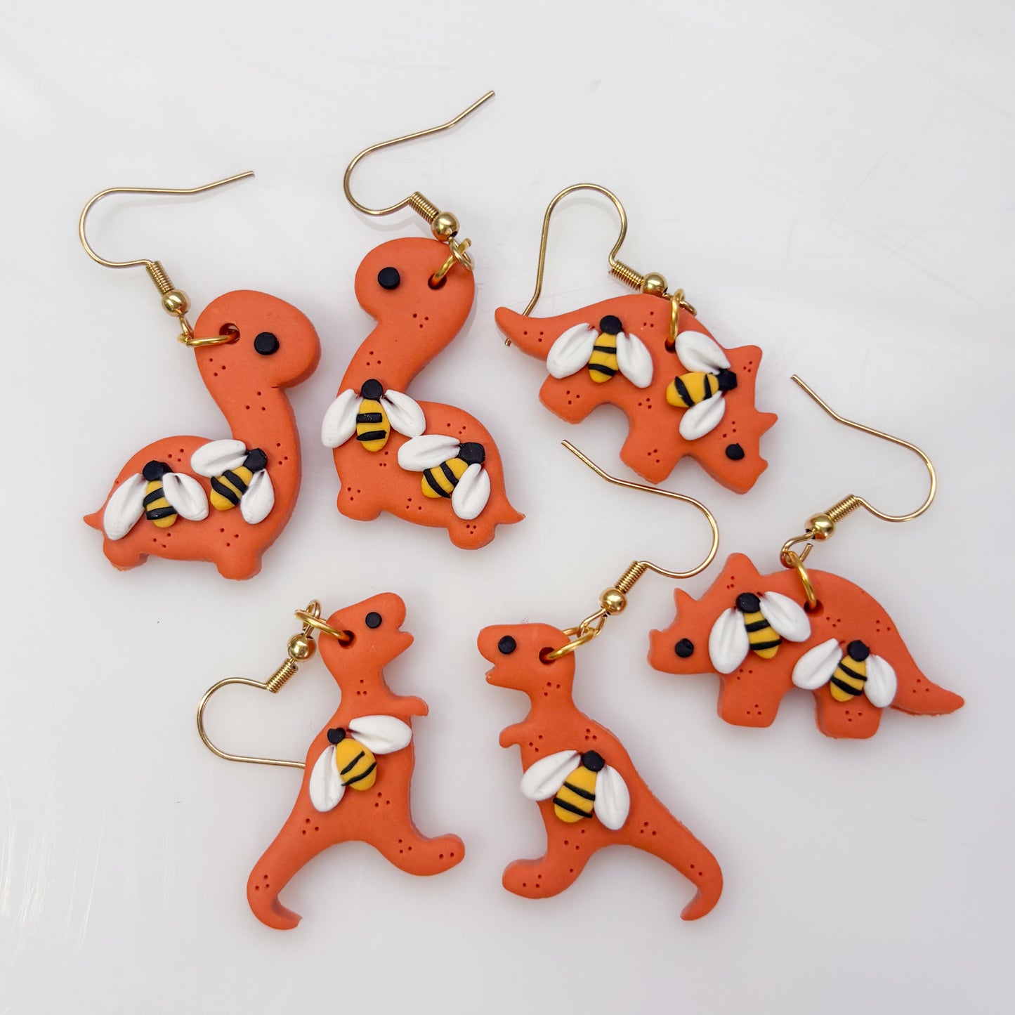 ORANGE BEE DINO EARRINGS (TRICERATOPS)