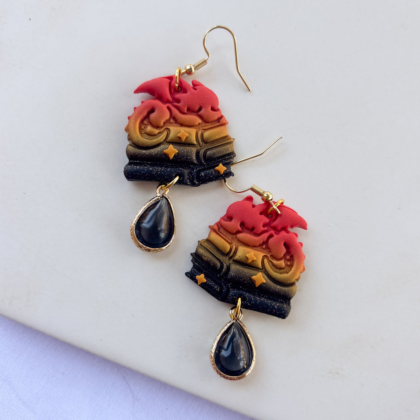 DRAGON ON BOOKS EARRINGS (RED ORANGE GOLD BLACK GLITTER)