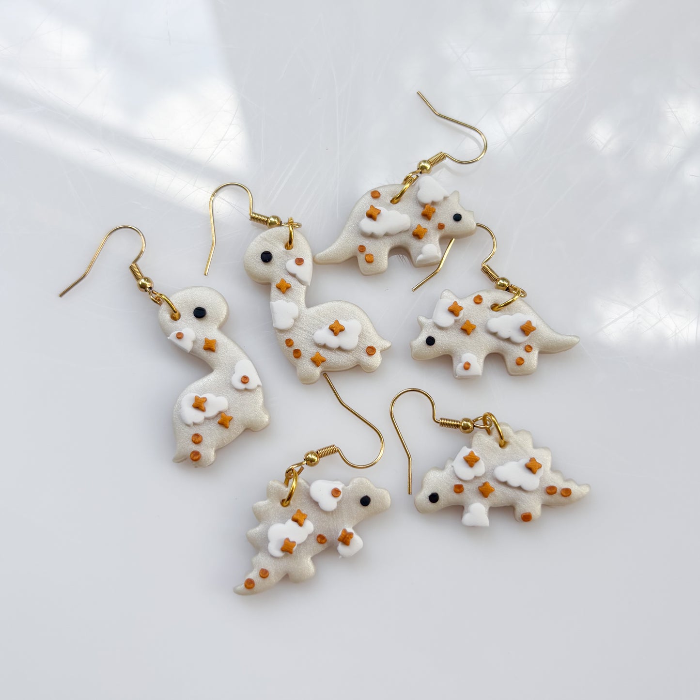 PEARL CLOUDY DINO EARRINGS (TRICERATOPS)