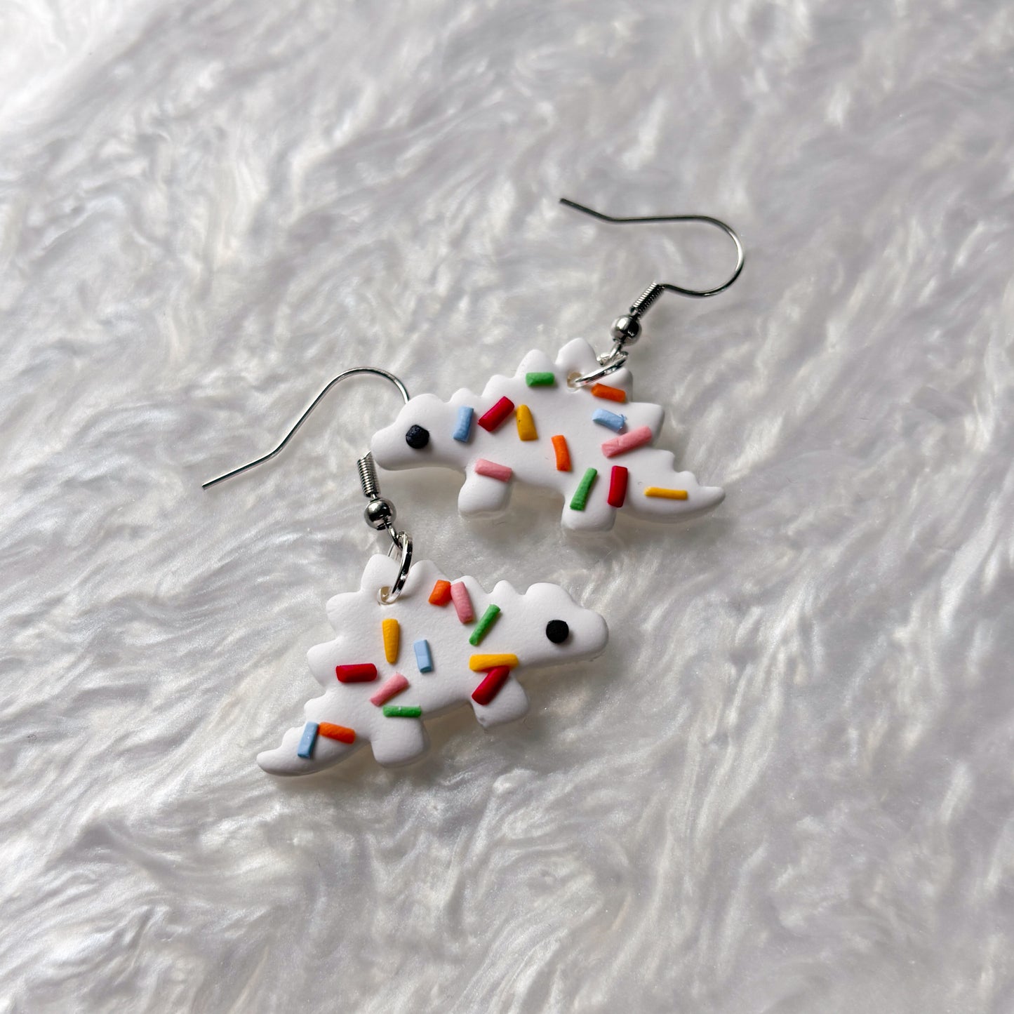 RAINBOW SPRINKLE DINO EARRINGS (STEGOSAURUS)