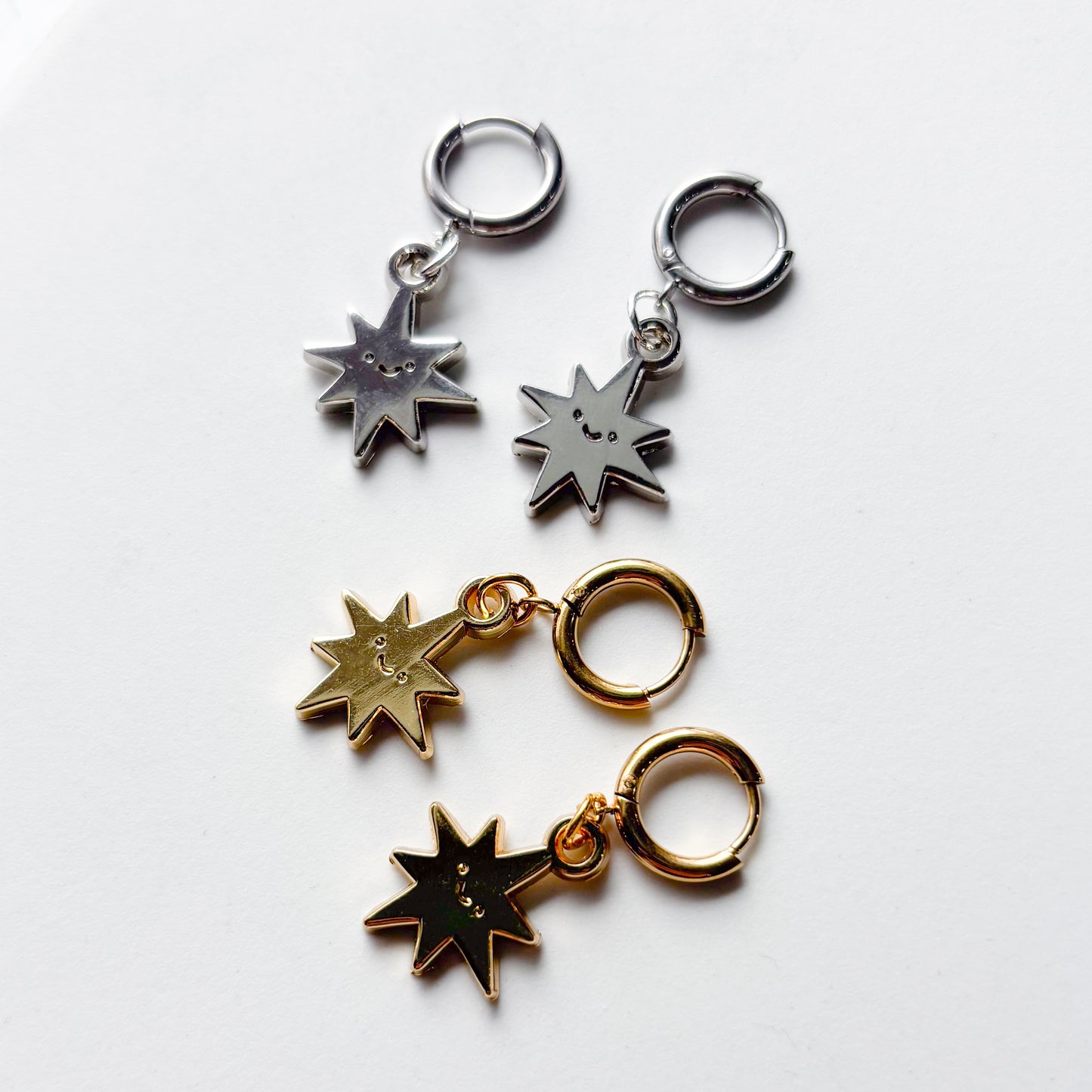 SMILING SPIKY STAR METAL HUGGIE HOOP EARRINGS