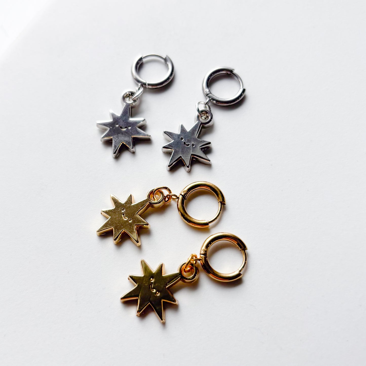 SMILING SPIKY STAR METAL HUGGIE HOOP EARRINGS