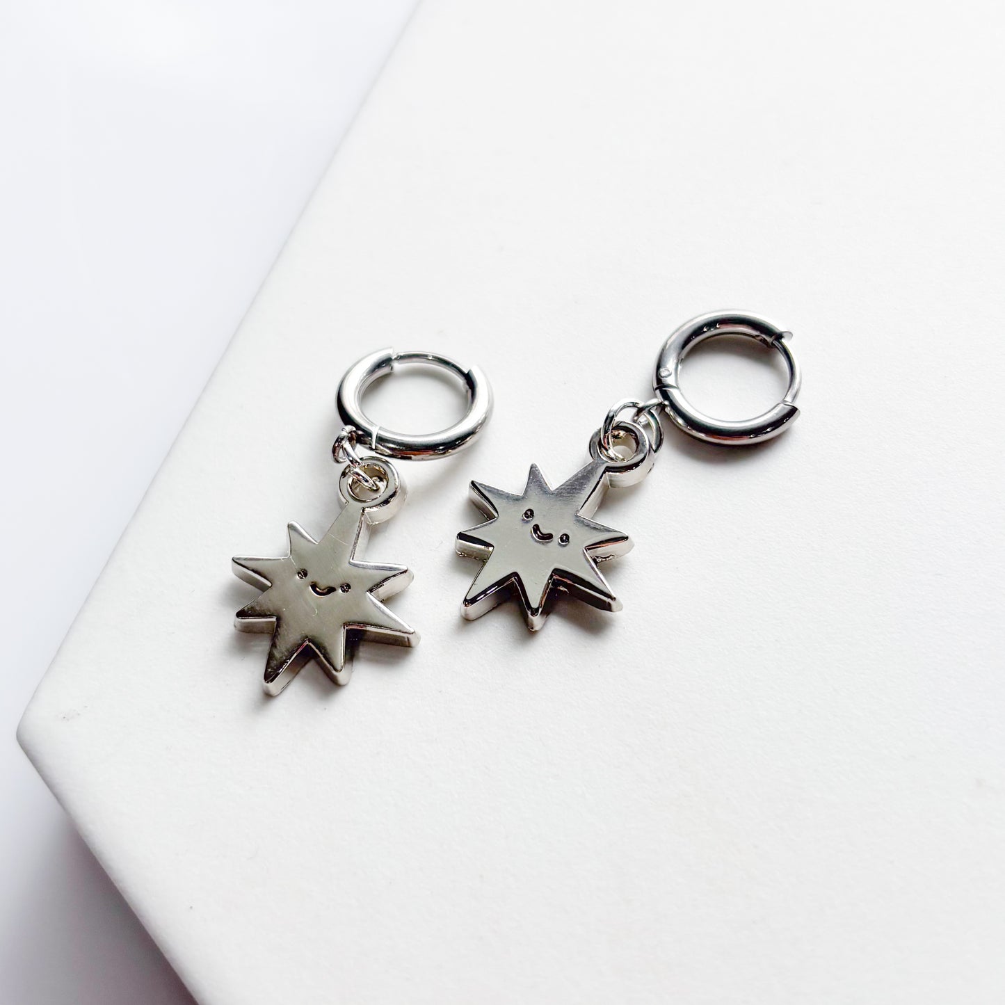 SMILING SPIKY STAR METAL HUGGIE HOOP EARRINGS