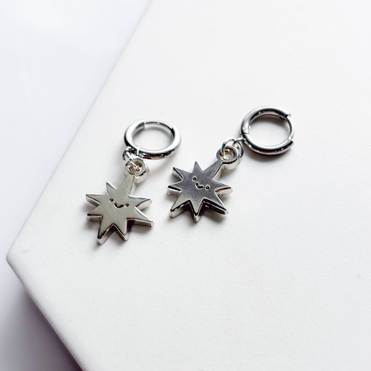 SMILING SPIKY STAR METAL HUGGIE HOOP EARRINGS