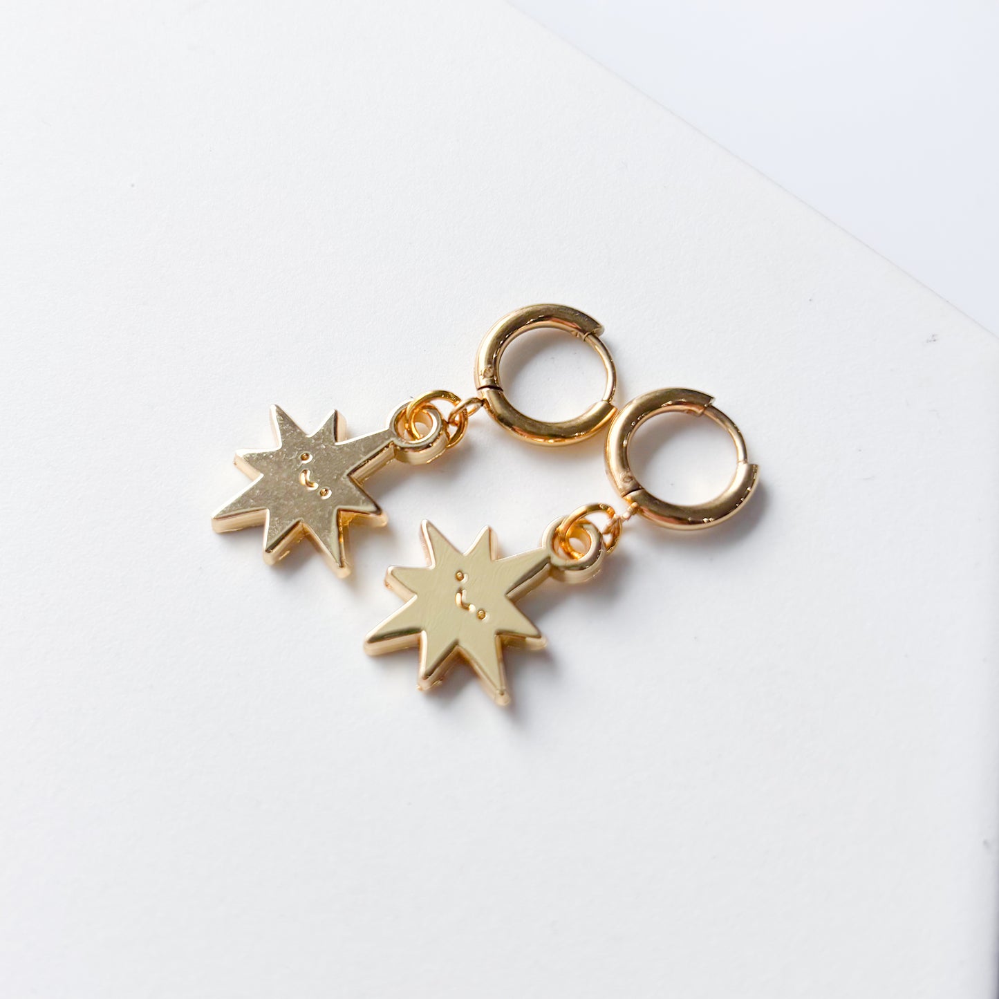 SMILING SPIKY STAR METAL HUGGIE HOOP EARRINGS